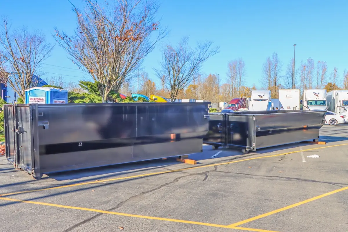 Professional dumpster rental service with roll-off container on residential driveway in Salina